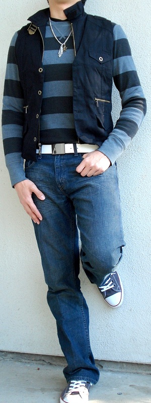 Casual Layered Black Utility Vest with Striped Sweater Dark Wash Jeans and Canvas Sneakers Outfit