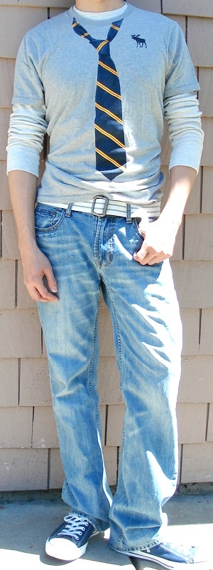Casual Layered Grey Graphic Tee Over Long Sleeve Shirt with Light Wash Jeans and Canvas Sneakers